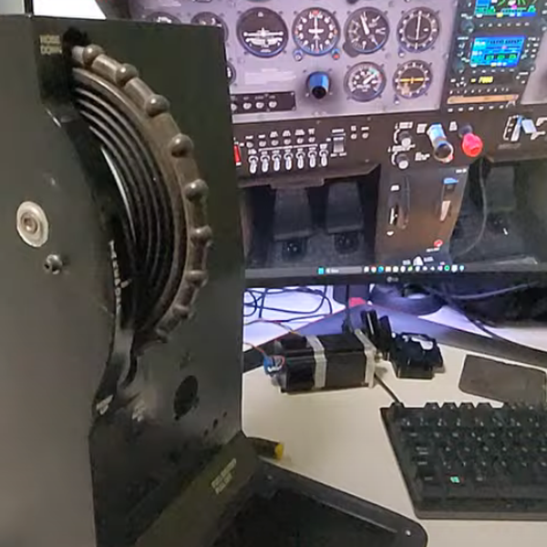 Motorized trim wheel installed in a flight simulator cockpit
